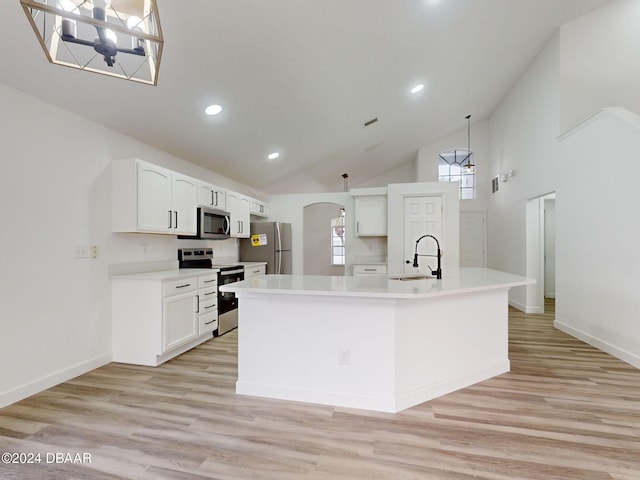 5336 Georgia Peach Ave, Port Orange, FL 32128 - kitchen featuring appliances with stainless steel finishes, a sink, high vaulted ceiling, arched walkways, and white cabinets