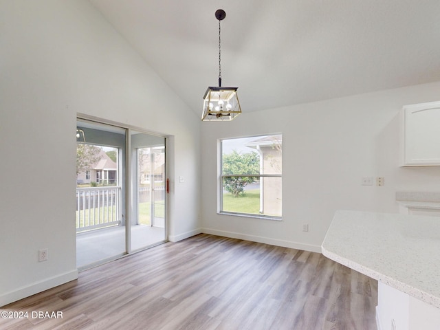 5336 Georgia Peach Ave, Port Orange, FL 32128 - unfurnished dining area featuring light wood-style floors, plenty of natural light, a chandelier, and lofted ceiling