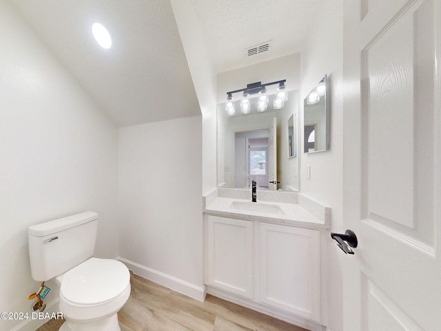5336 Georgia Peach Ave, Port Orange, FL 32128 - bathroom featuring toilet, wood finished floors, baseboards, and vanity