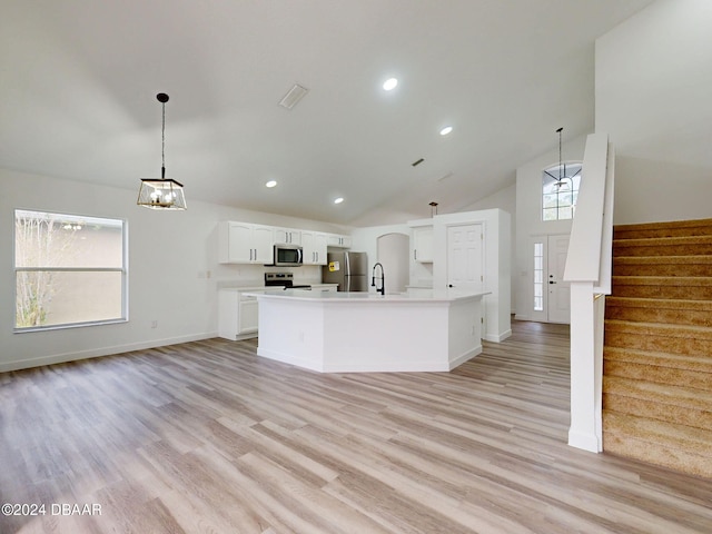 5336 Georgia Peach Ave, Port Orange, FL 32128 - kitchen featuring stainless steel appliances, open floor plan, white cabinetry, a sink, and high vaulted ceiling