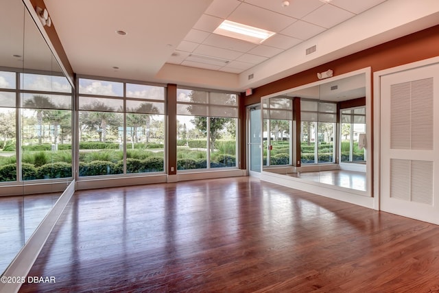 231 Riverside Dr Unit 1801, Daytona Beach, FL 32117 - interior space with expansive windows, visible vents, a paneled ceiling, and wood finished floors