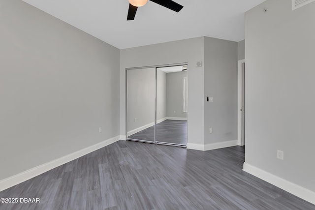 231 Riverside Dr Unit 1801, Daytona Beach, FL 32117 - unfurnished bedroom featuring dark wood-style flooring, a closet, visible vents, a ceiling fan, and baseboards