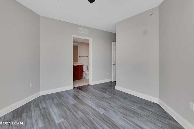 231 Riverside Dr Unit 1801, Daytona Beach, FL 32117 - unfurnished room featuring visible vents, ceiling fan, baseboards, and wood finished floors