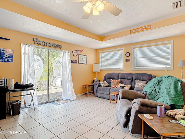 413 Frances Ter, Daytona Beach, FL 32118 - living area with light tile patterned flooring, ceiling fan, healthy amount of natural light, and a textured ceiling