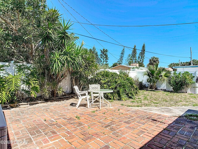 413 Frances Ter, Daytona Beach, FL 32118 - fenced backyard featuring a patio area and outdoor dining area