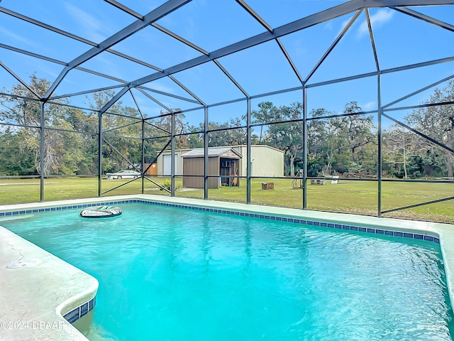 view of swimming pool with a lanai, a yard, and a storage shed