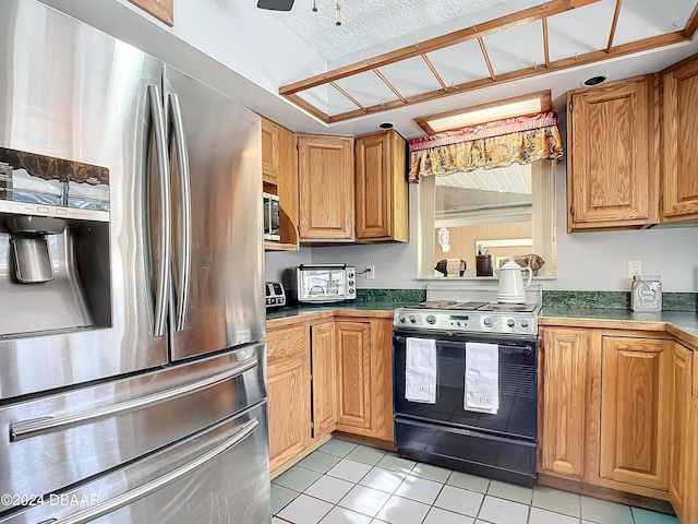 kitchen featuring stainless steel fridge with ice dispenser, black range with electric cooktop, light tile patterned floors, and ceiling fan