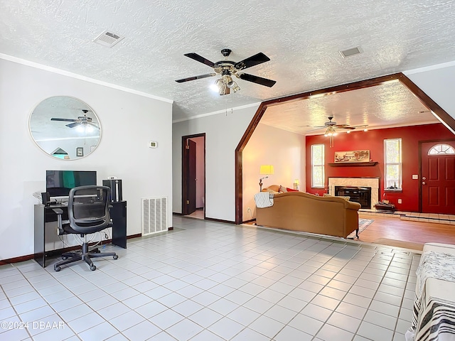 tiled home office featuring a textured ceiling and ornamental molding