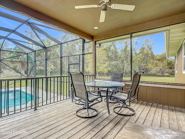 unfurnished sunroom with vaulted ceiling and ceiling fan