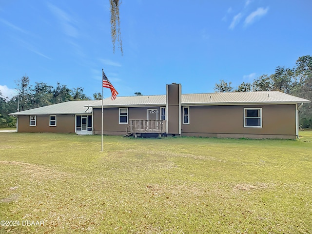 rear view of property featuring a yard