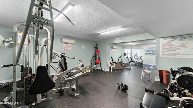 gym with a wall mounted AC and a textured ceiling