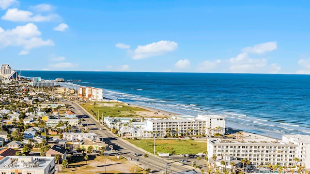 drone / aerial view featuring a water view and a view of the beach