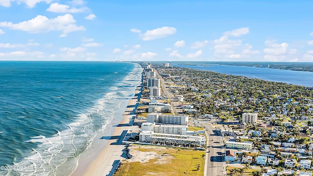 aerial view with a water view and a beach view