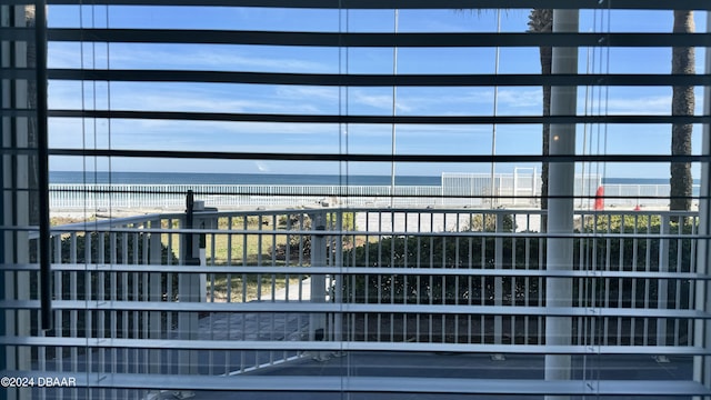 view of property with a water view and a view of the beach