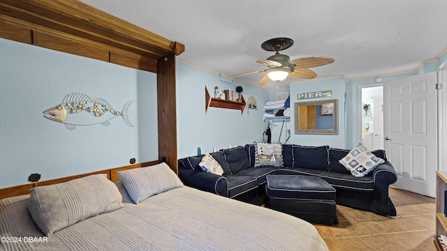 tiled bedroom with a textured ceiling, ceiling fan, and ornamental molding