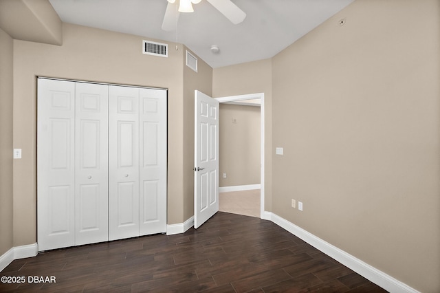 unfurnished bedroom featuring dark hardwood / wood-style flooring, a closet, and ceiling fan