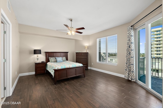 bedroom with ceiling fan, access to outside, multiple windows, and dark hardwood / wood-style floors