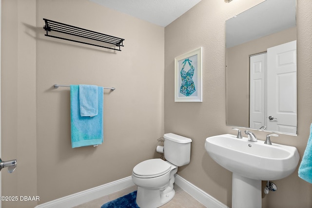 bathroom with toilet and tile patterned floors