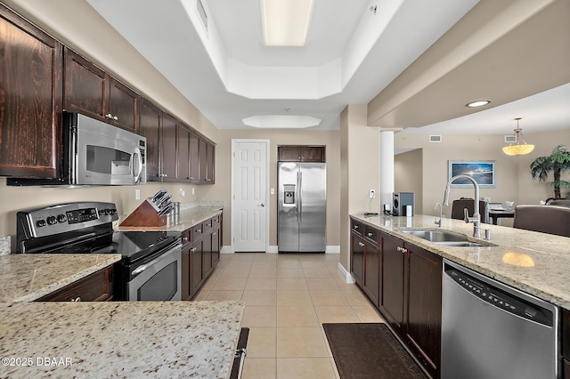 kitchen featuring stainless steel appliances, sink, light tile patterned floors, and light stone countertops