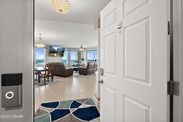 entrance foyer with light tile patterned flooring and ceiling fan