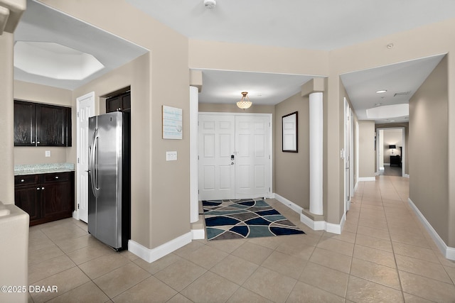 foyer entrance with light tile patterned floors