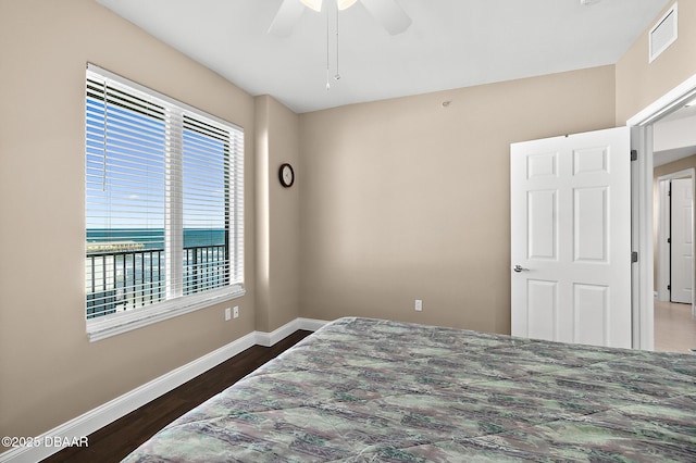 bedroom with ceiling fan and dark wood-type flooring