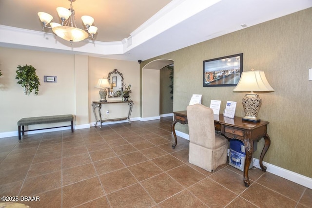 office space with ornamental molding, an inviting chandelier, and a tray ceiling