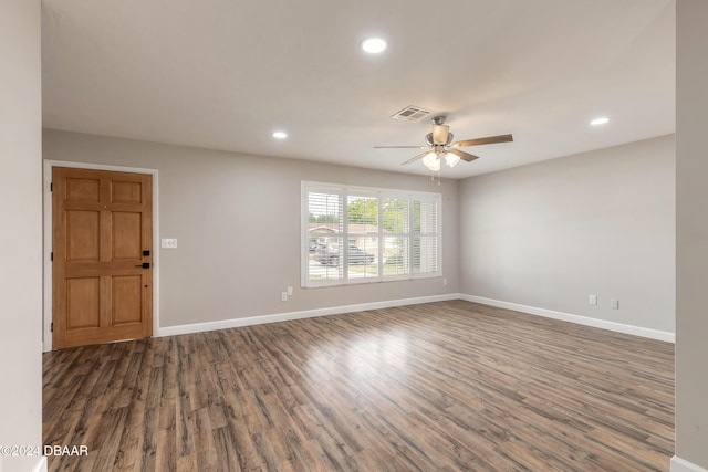 empty room featuring dark hardwood / wood-style flooring and ceiling fan