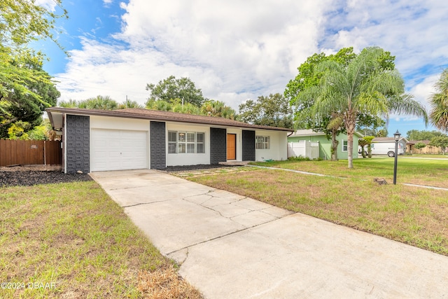 ranch-style house featuring a garage and a front lawn