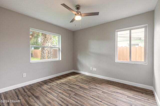 spare room with hardwood / wood-style flooring and ceiling fan