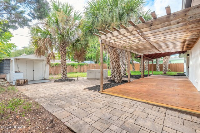 view of patio with a pergola and a storage unit