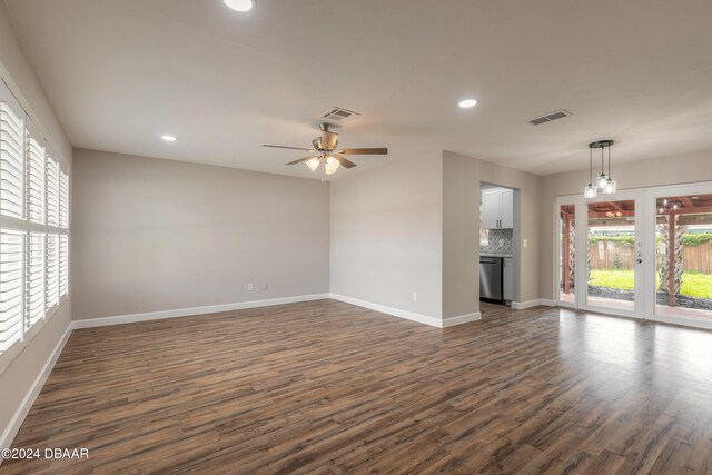 unfurnished living room with ceiling fan and dark hardwood / wood-style flooring