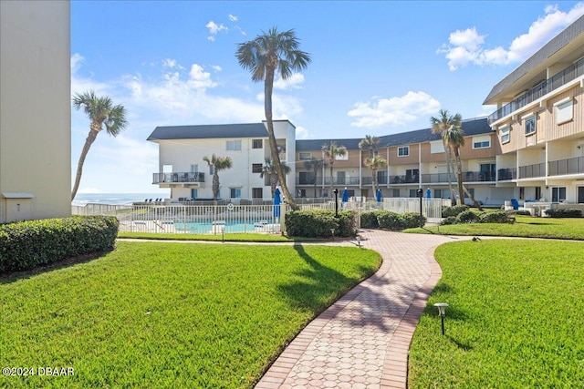 view of community featuring a yard and a pool