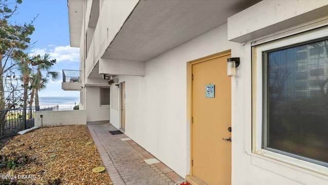 doorway to property with a water view