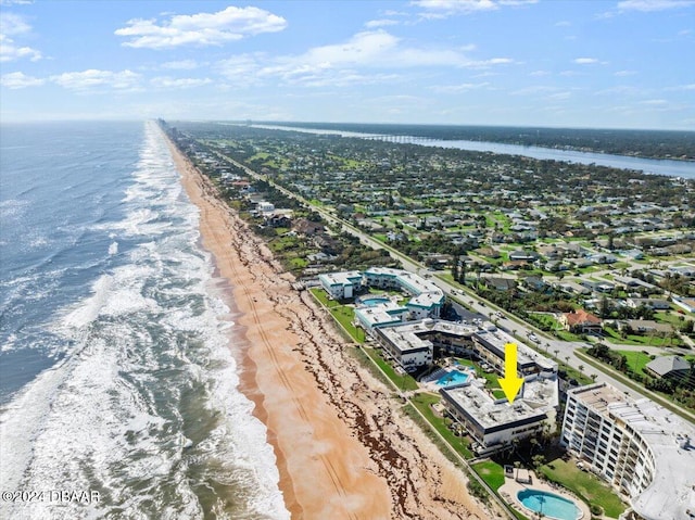 drone / aerial view featuring a view of the beach and a water view