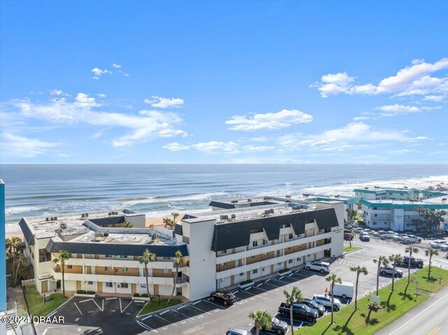 birds eye view of property featuring a water view and a beach view