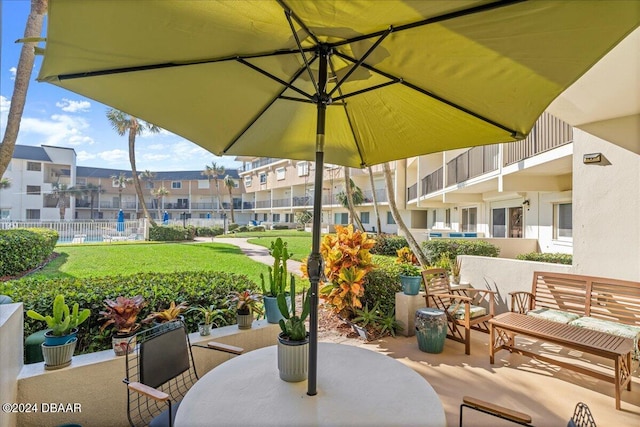 view of patio featuring a balcony