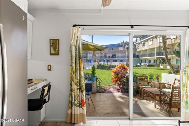 doorway to outside with light tile patterned floors