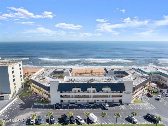 drone / aerial view with a water view and a beach view