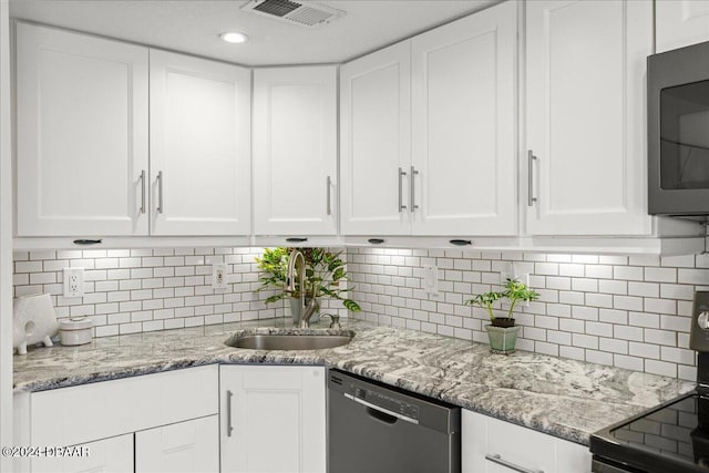 kitchen with stainless steel appliances, white cabinets, and sink