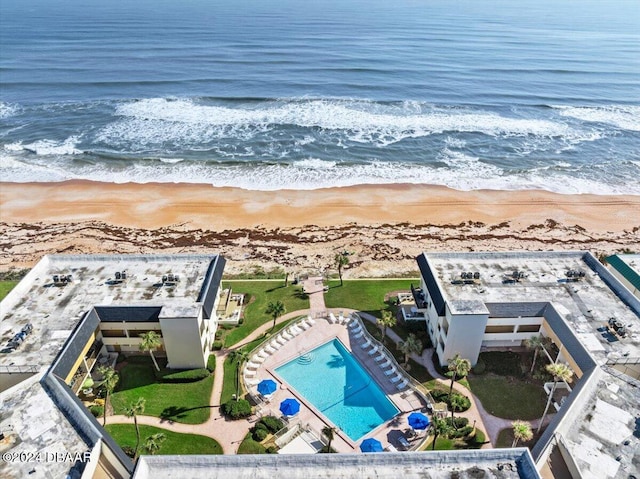 aerial view with a water view and a beach view