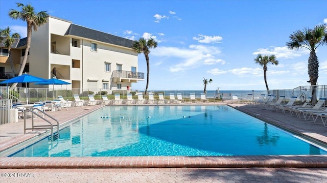 view of swimming pool featuring a water view