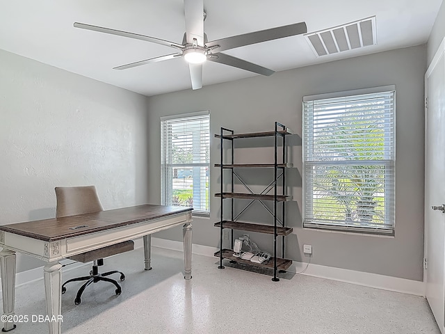 home office with ceiling fan, baseboards, and speckle patterned floor