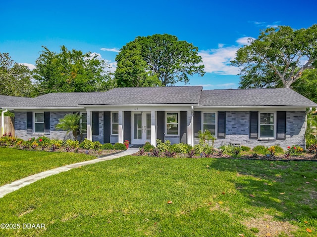 ranch-style house with a front lawn and a shingled roof