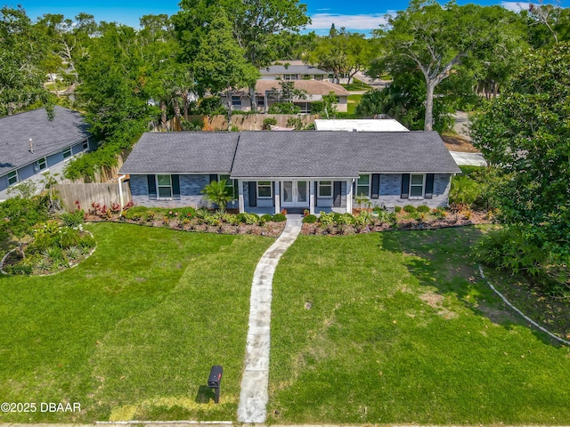 ranch-style house featuring stone siding and roof with shingles