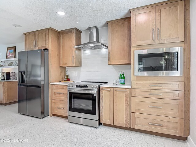 kitchen with stainless steel appliances, wall chimney exhaust hood, light countertops, backsplash, and a textured ceiling