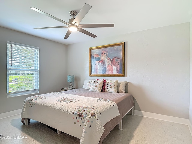 bedroom featuring baseboards and ceiling fan