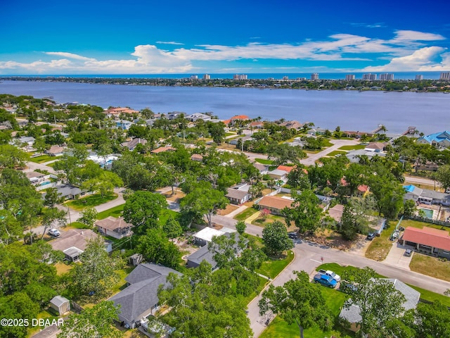 aerial view of property and surrounding area with a nearby body of water and nearby suburban area