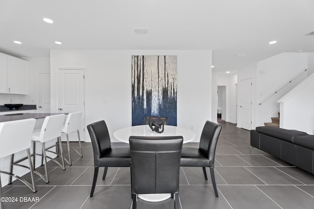 dining room with dark tile patterned floors