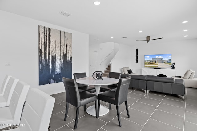 tiled dining room featuring ceiling fan